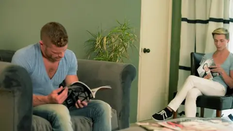 A burly male initiates a twink into gay sex