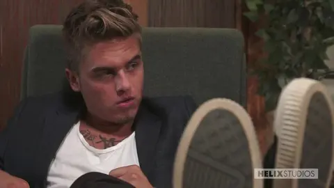 The photographer watches his models having sex.